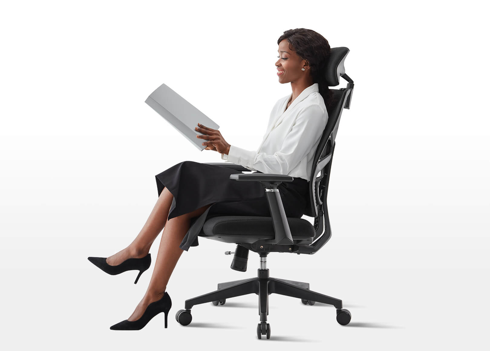 Female Model Reading on Black Voyager Pro Ergonomic Task Chair with 3D Armrests and Lockable Backrest